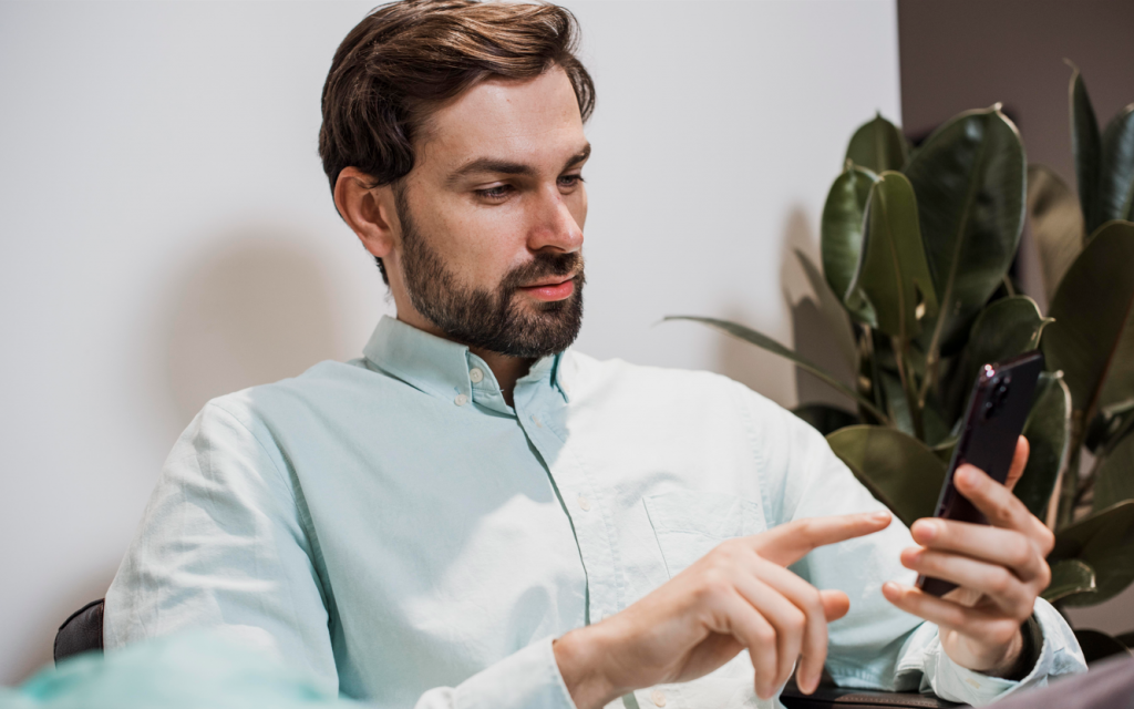 A man scrolling on his smartphone.